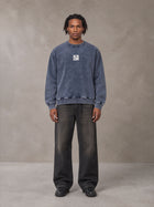 Model wearing the SM Denim Wash Sweatshirt in Oxford Navy, front view.