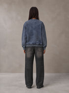 Model wearing the SM Denim Wash Sweatshirt in Oxford Navy, rear view.