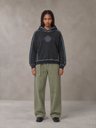 Model wearing the SM Eternal Fleur Belted Trousers in Heritage Khaki, front view.