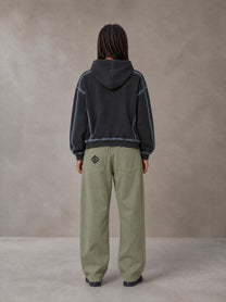 Model wearing the SM Eternal Fleur Belted Trousers in Heritage Khaki, rear view.