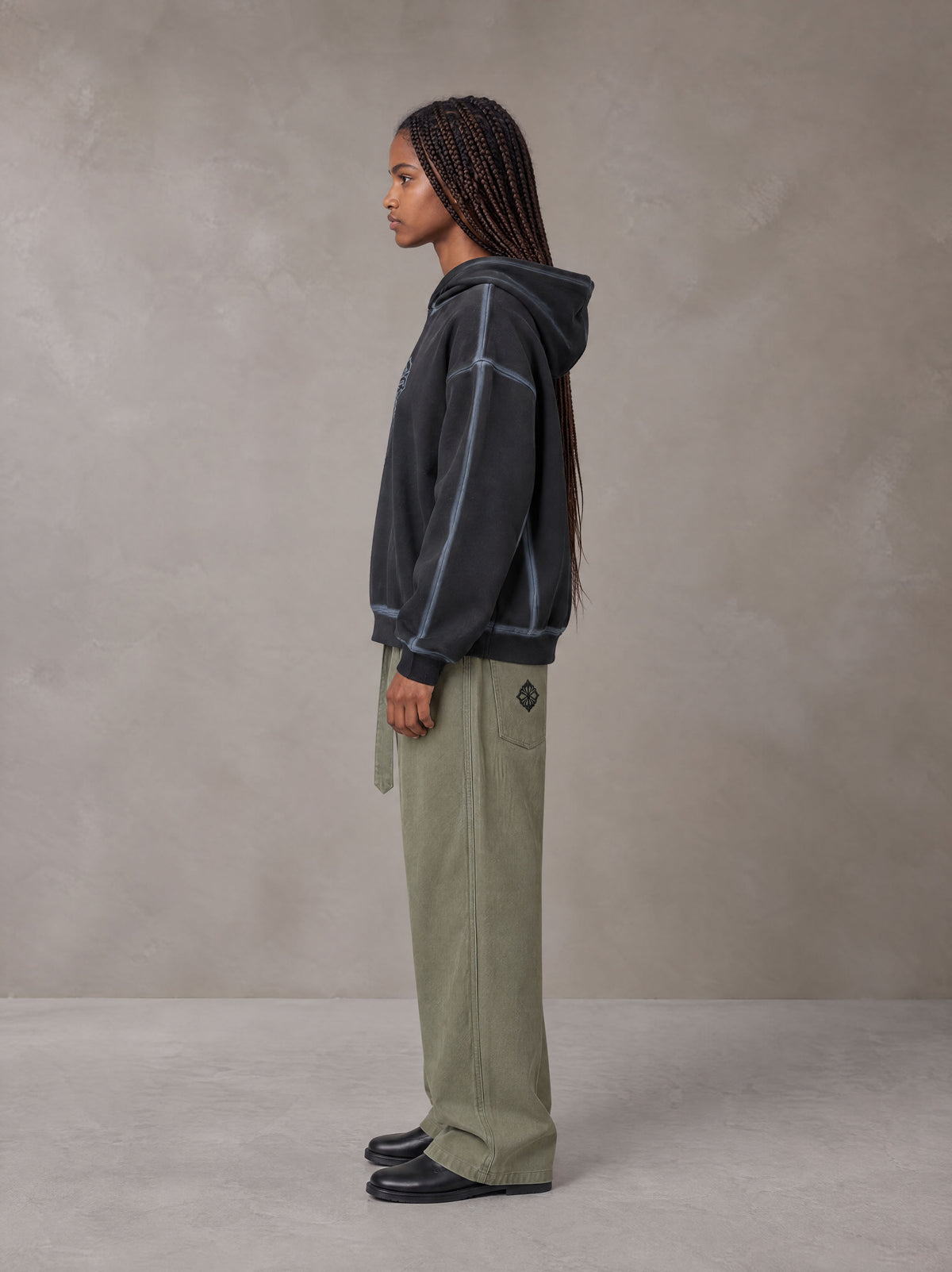 Model wearing the SM Eternal Fleur Belted Trousers in Heritage Khaki, side profile.