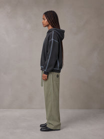 Model wearing the SM Eternal Fleur Belted Trousers in Heritage Khaki, side profile.