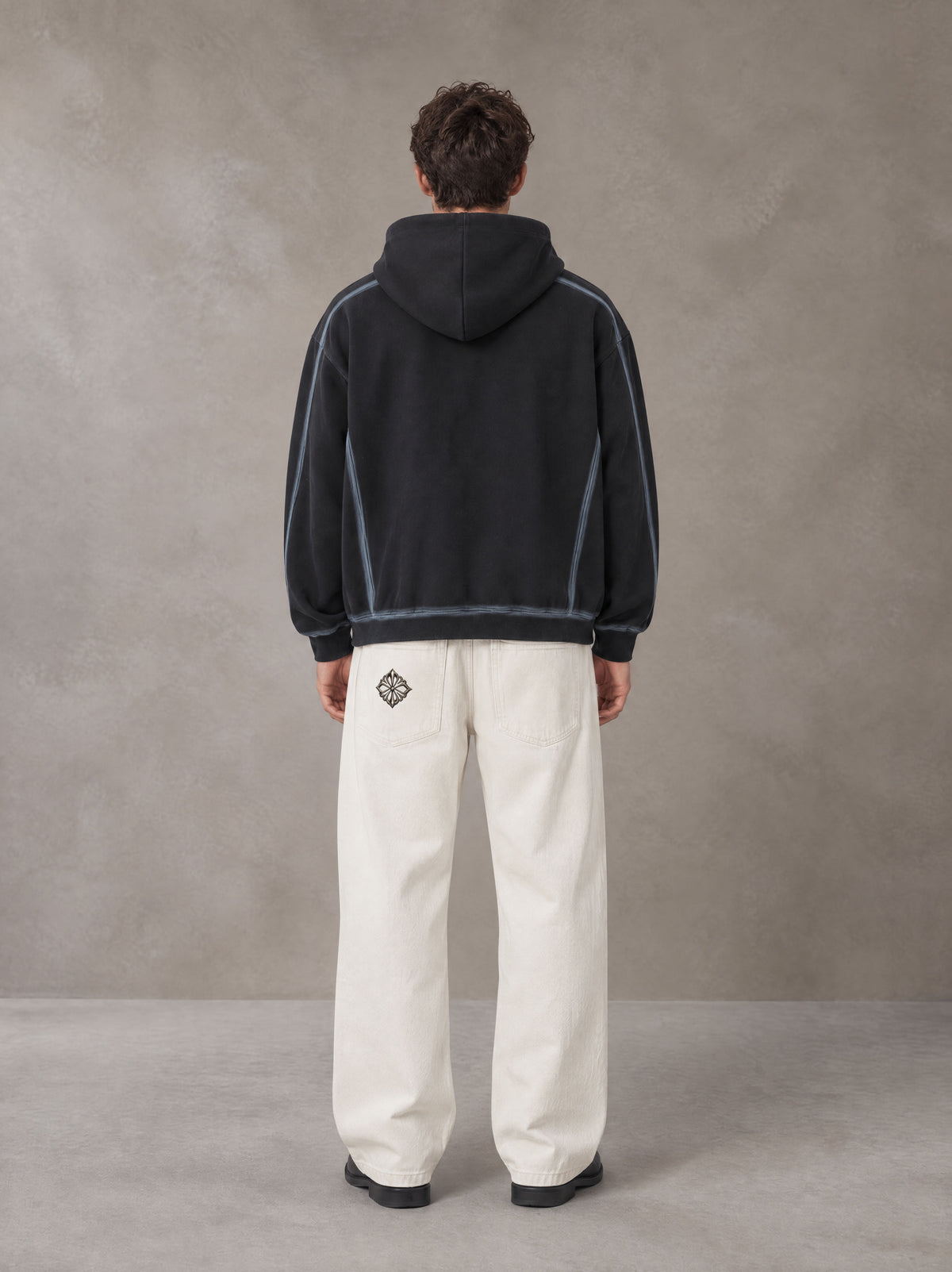 Model wearing the SM Eternal Fleur Belted Trousers in Ivory White, rear view.