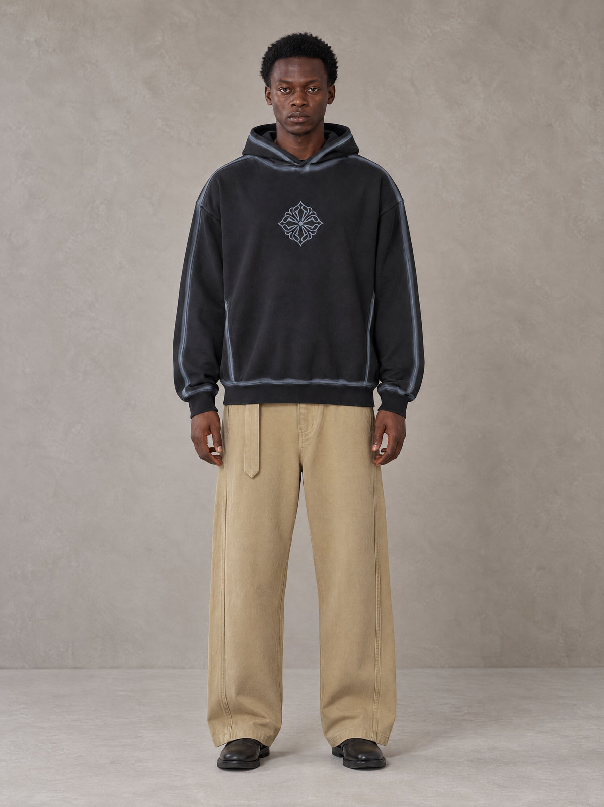 Model wearing the SM Eternal Fleur Belted Trousers in Camel Tan, front view.