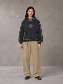 Model wearing the SM Eternal Fleur Belted Trousers in Camel Tan, front view.