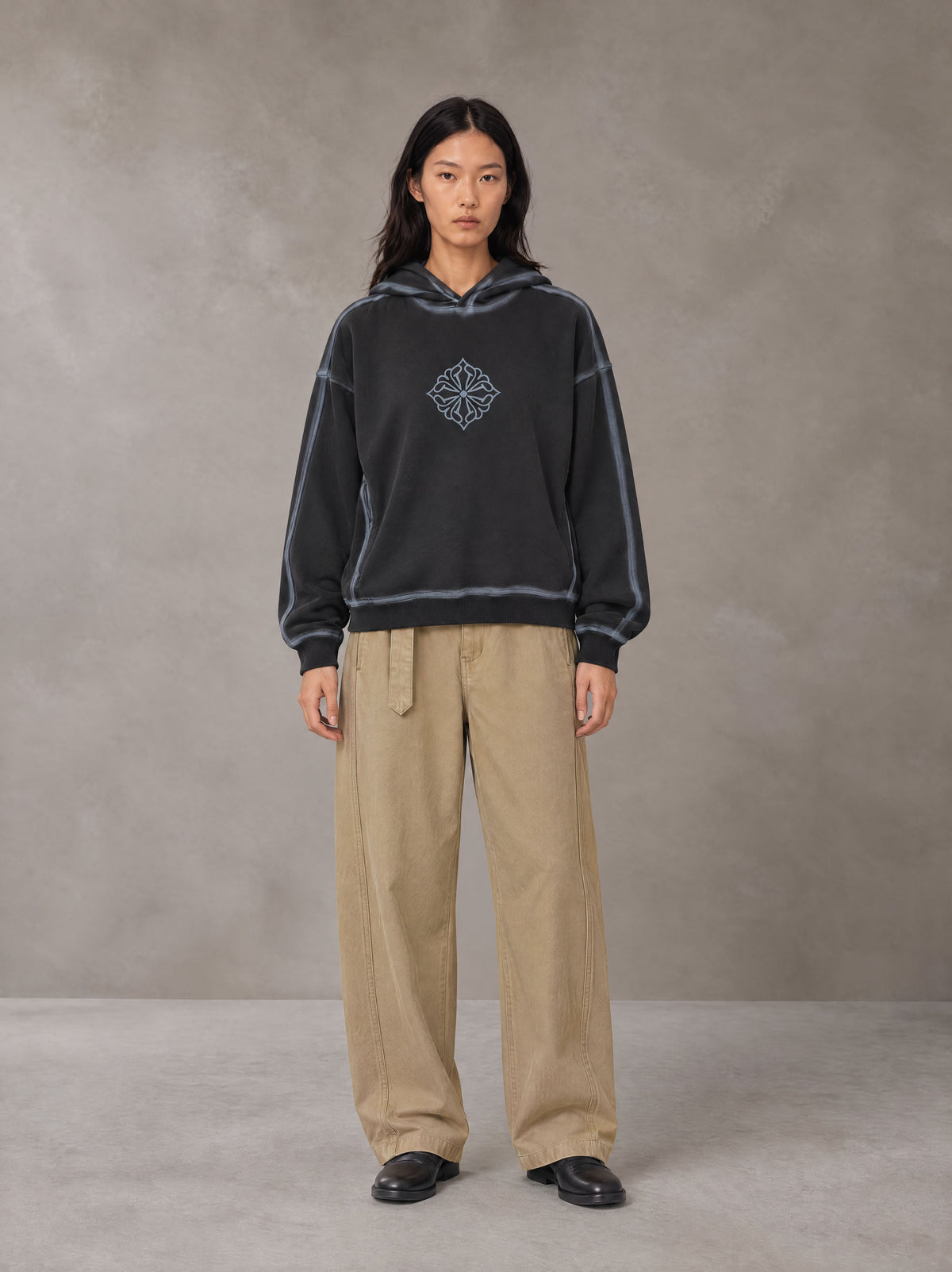 Model wearing the SM Eternal Fleur Belted Trousers in Camel Tan, front view.