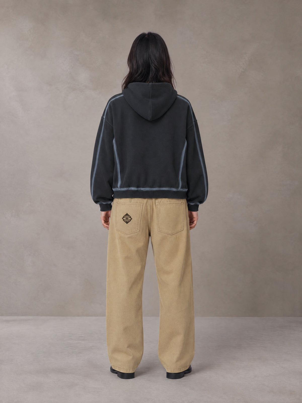 Model wearing the SM Eternal Fleur Belted Trousers in Camel Tan, rear view.
