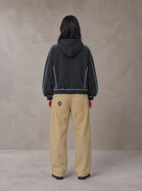 Model wearing the SM Eternal Fleur Belted Trousers in Camel Tan, rear view.