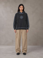Model wearing the SM Eternal Fleur Cargo Trousers in Camel Tan, front view.