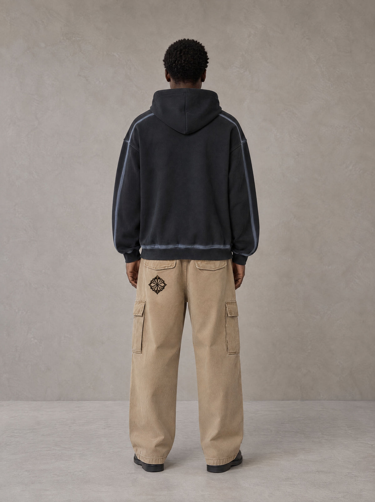 Model wearing the SM Eternal Fleur Cargo Trousers in Camel Tan, rear view.