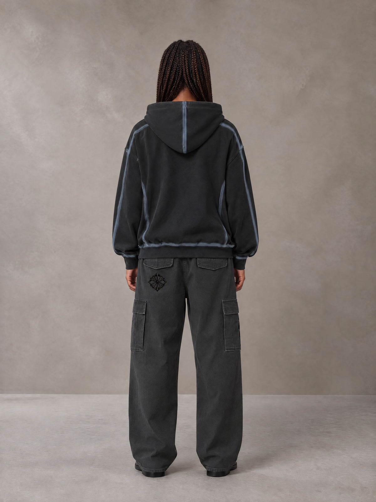 Model wearing the SM Eternal Fleur Cargo Trousers in Deep Charcoal, rear view.