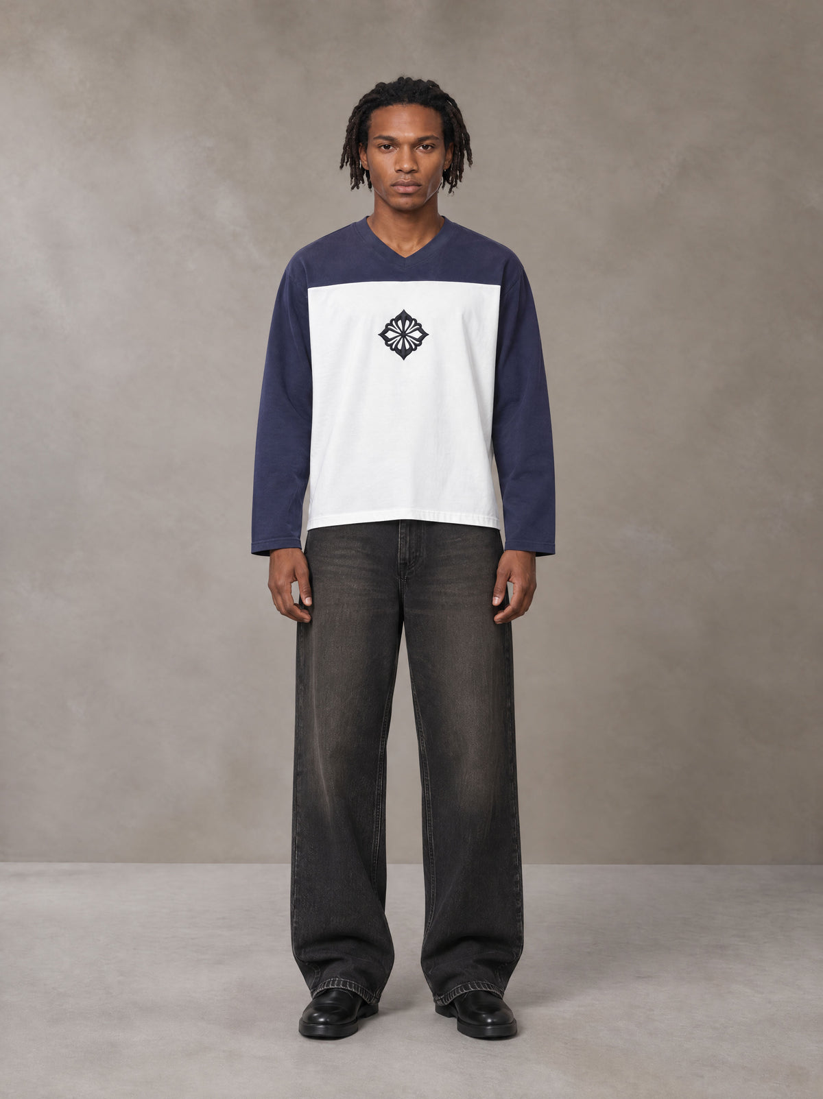 Model wearing the SM Eternal Fleur Forme T-shirt in Deep Purple, front view.