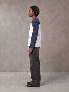 Model wearing the SM Eternal Fleur Forme T-shirt in Deep Purple, side profile.