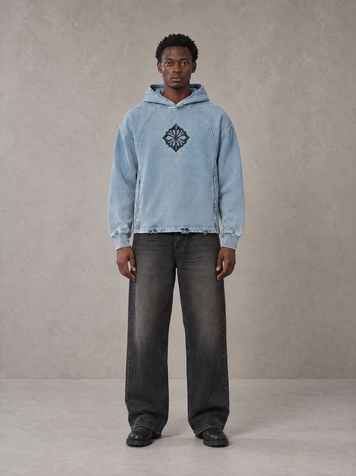 Model wearing the SM Eternal Fleur Hoodie in Washed Blue Jean, front view.