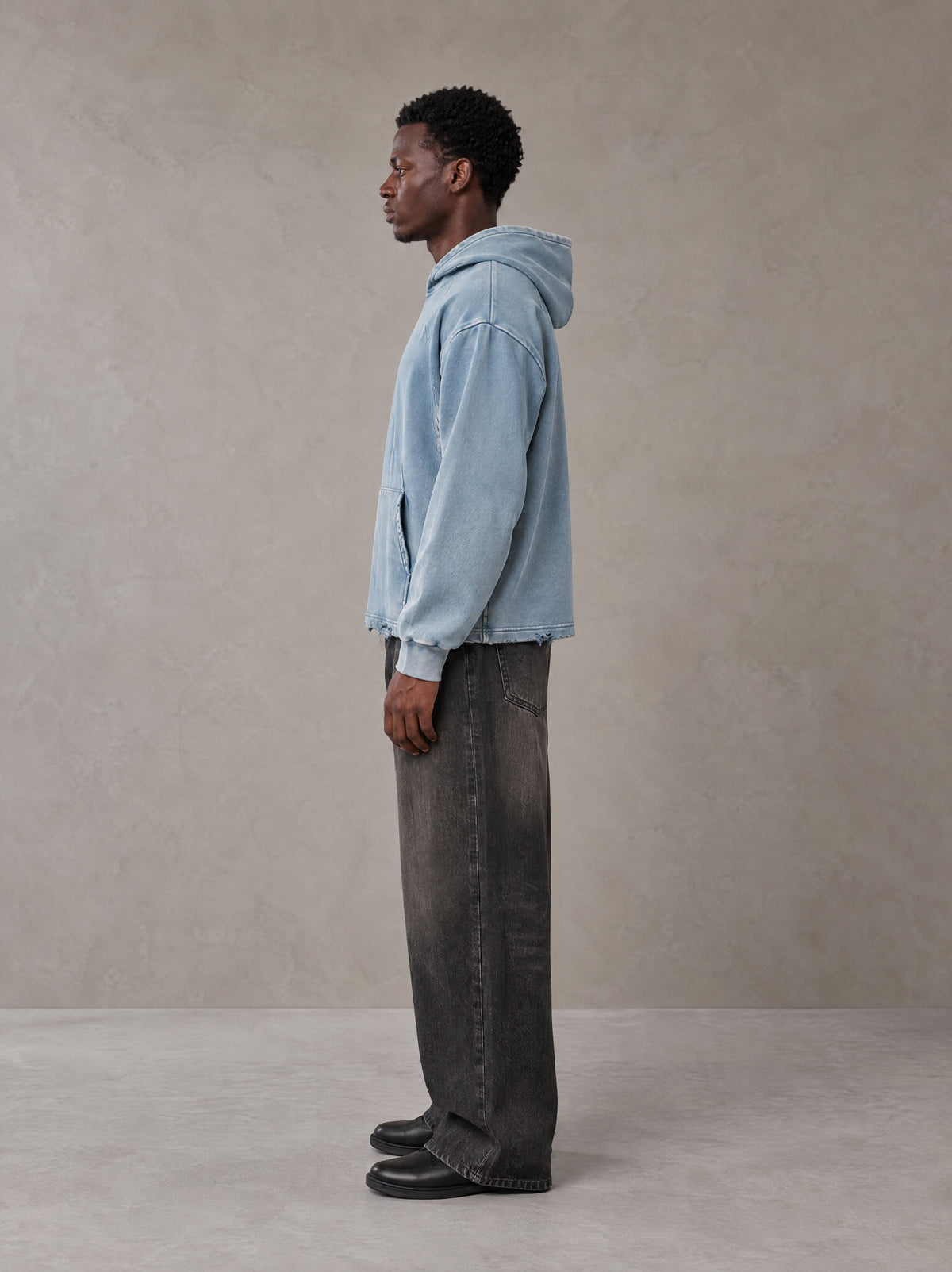 Model wearing the SM Eternal Fleur Hoodie in Washed Blue Jean, side profile.