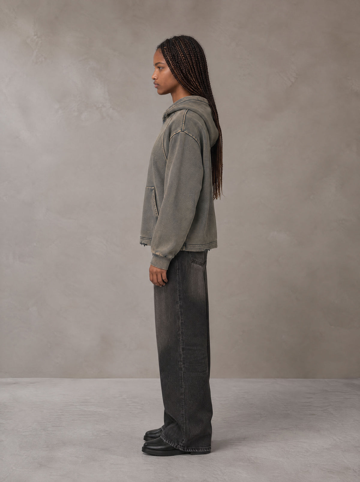 Model wearing the SM Eternal Fleur Hoodie in Stone Grey, side profile.