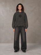 Model wearing the SM Eternal Fleur Hoodie in Deep Charcoal, front view.