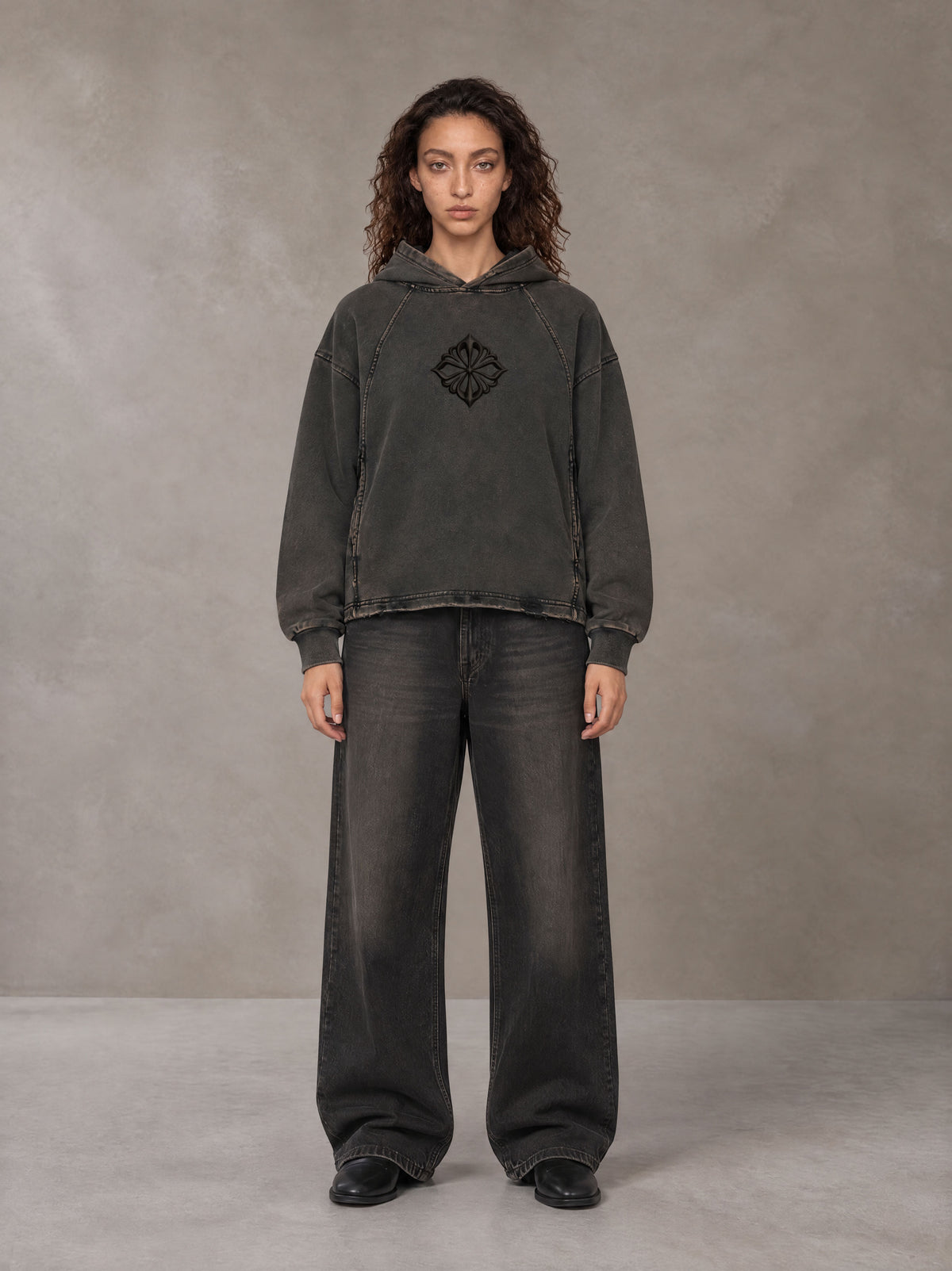 Model wearing the SM Eternal Fleur Hoodie in Deep Charcoal, front view.
