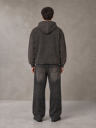 Model wearing the SM Eternal Fleur Hoodie in Deep Charcoal, rear view.