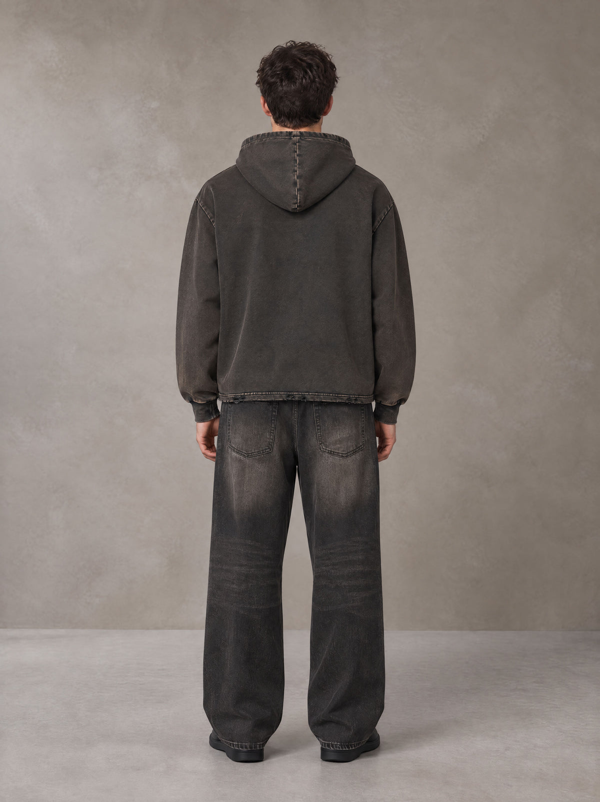 Model wearing the SM Eternal Fleur Hoodie in Deep Charcoal, rear view.