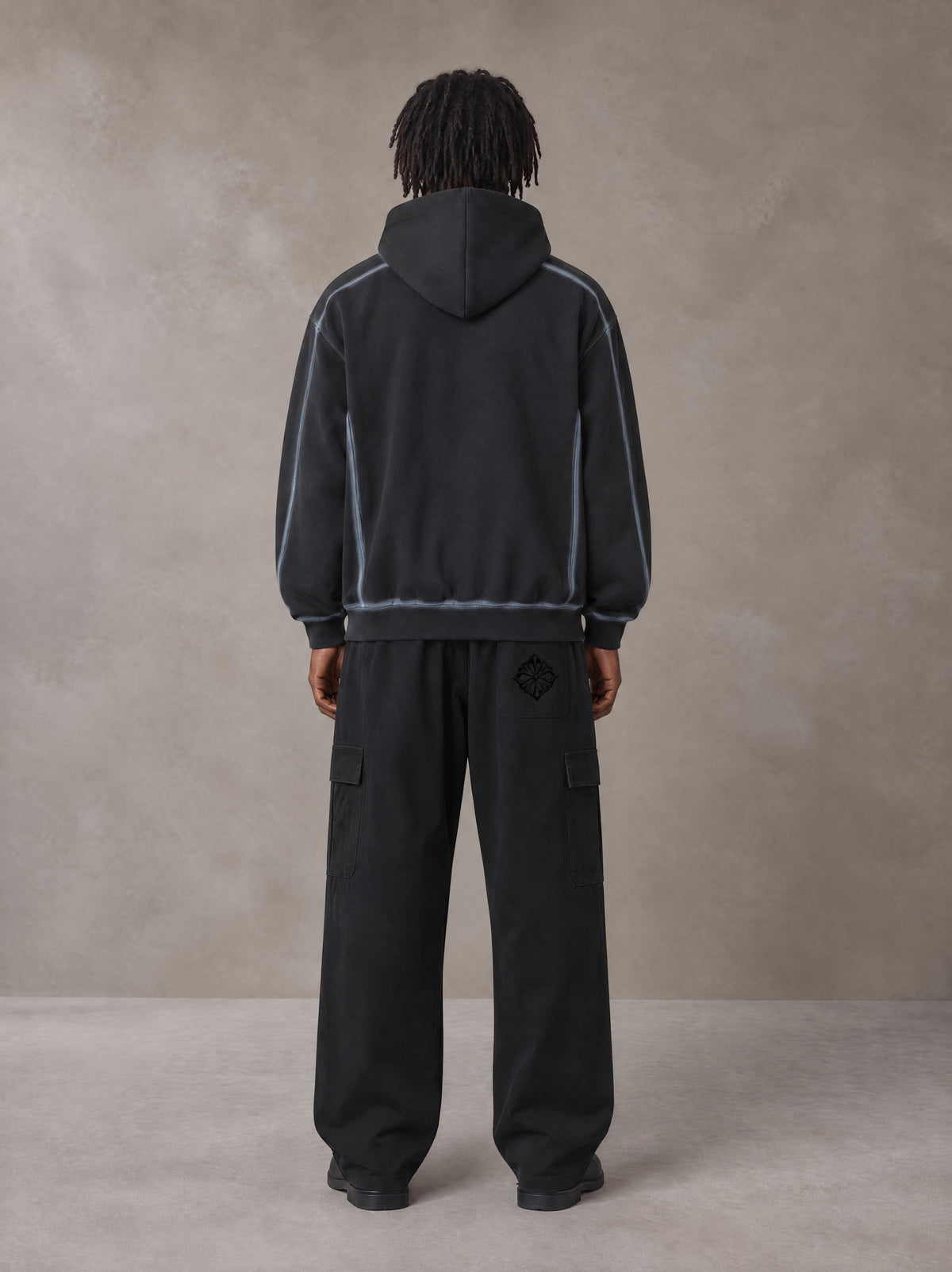 Model wearing the SM Eternal Fleur Straight Leg Cargo Pants in Midnight Black, rear view.