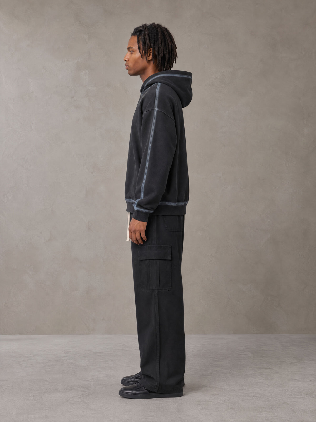 Model wearing the SM Eternal Fleur Straight Leg Cargo Pants in Midnight Black, side profile.