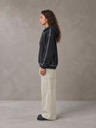 Model wearing the SM Eternal Fleur Straight Leg Cargo Pants in Oat Grey, side profile.