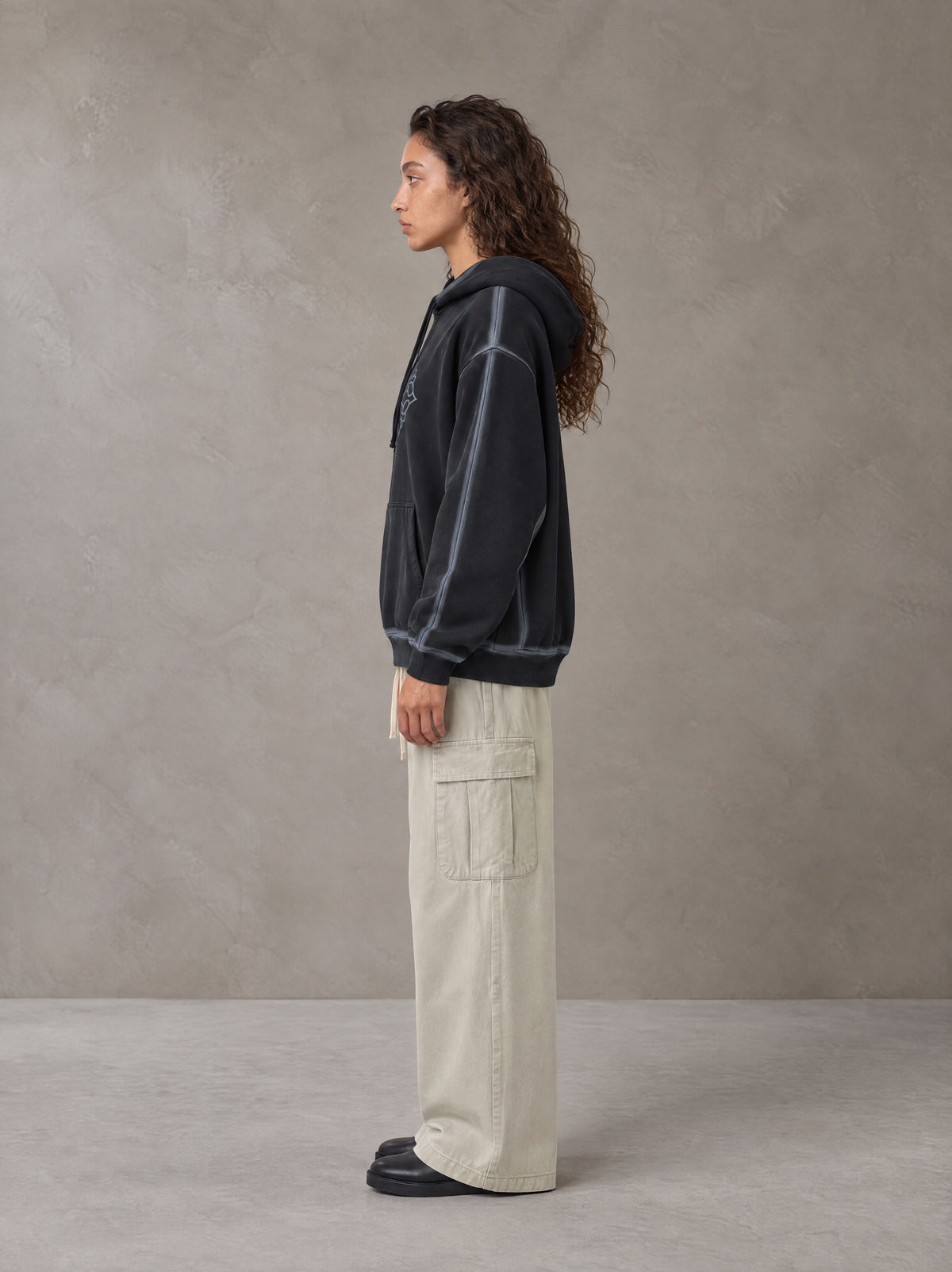 Model wearing the SM Eternal Fleur Straight Leg Cargo Pants in Oat Grey, side profile.