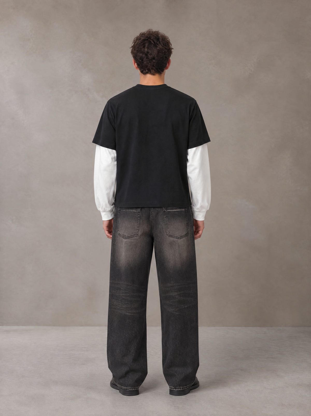 Model wearing the SM Eternal Fleur T-shirt in Midnight Black, rear view.