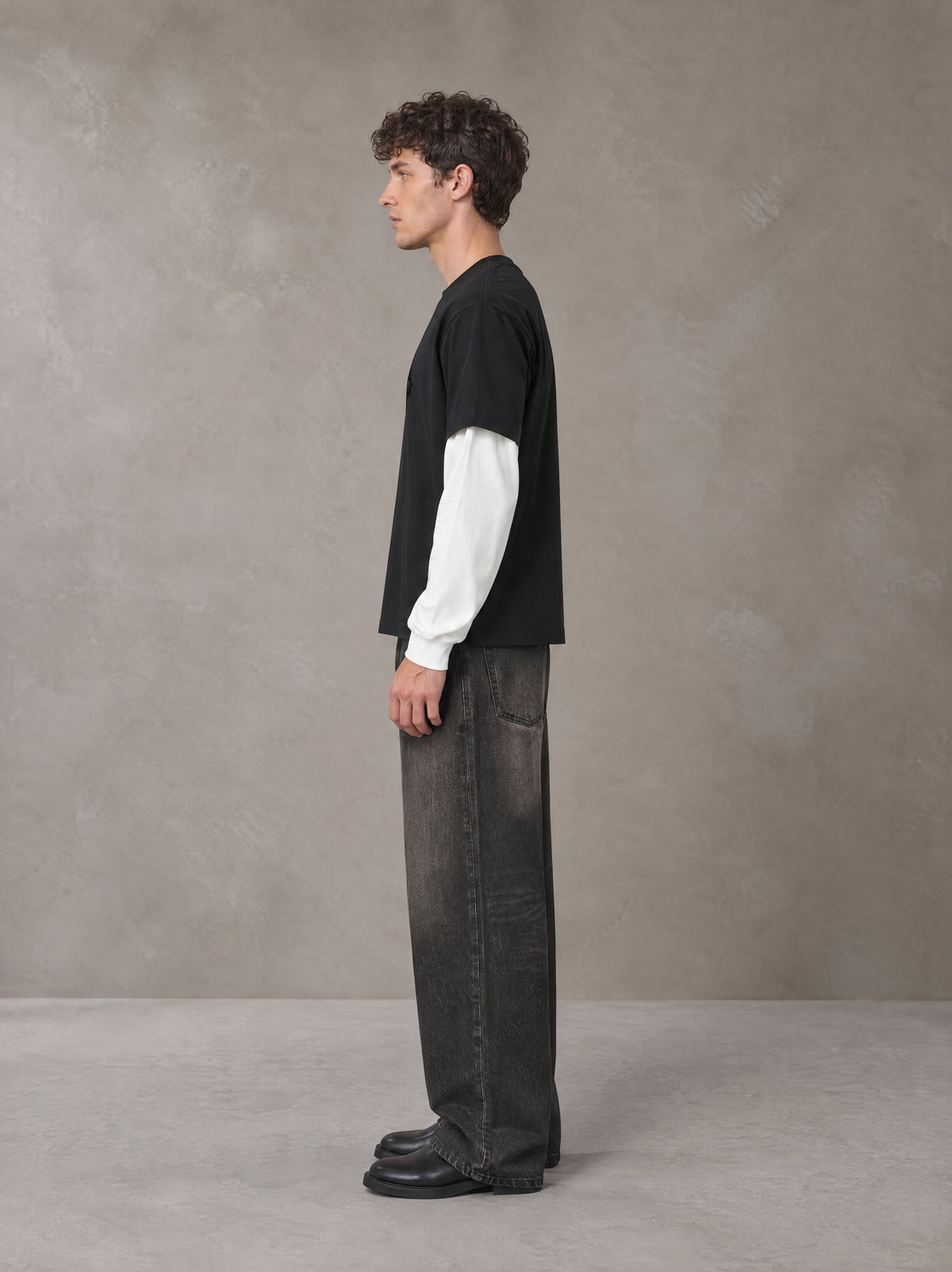 Model wearing the SM Eternal Fleur T-shirt in Midnight Black, side profile.