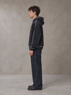 Model wearing the SM Heritage Straight Leg Denim Jeans in Ebony Clay, side profile.