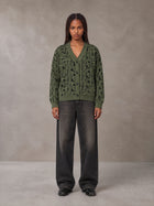 Model wearing the SM Abstract Jacquard Knitted Cardigan in Olive Shade, front view.