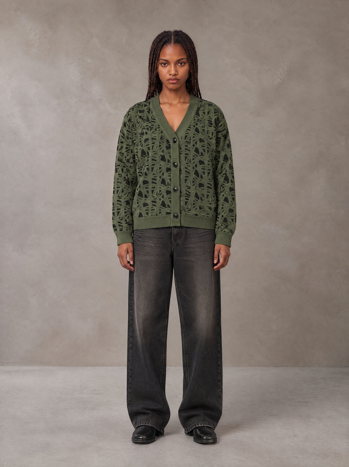 Model wearing the SM Abstract Jacquard Knitted Cardigan in Olive Shade, front view.