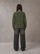 Model wearing the SM Abstract Jacquard Knitted Cardigan in Olive Shade, rear view.