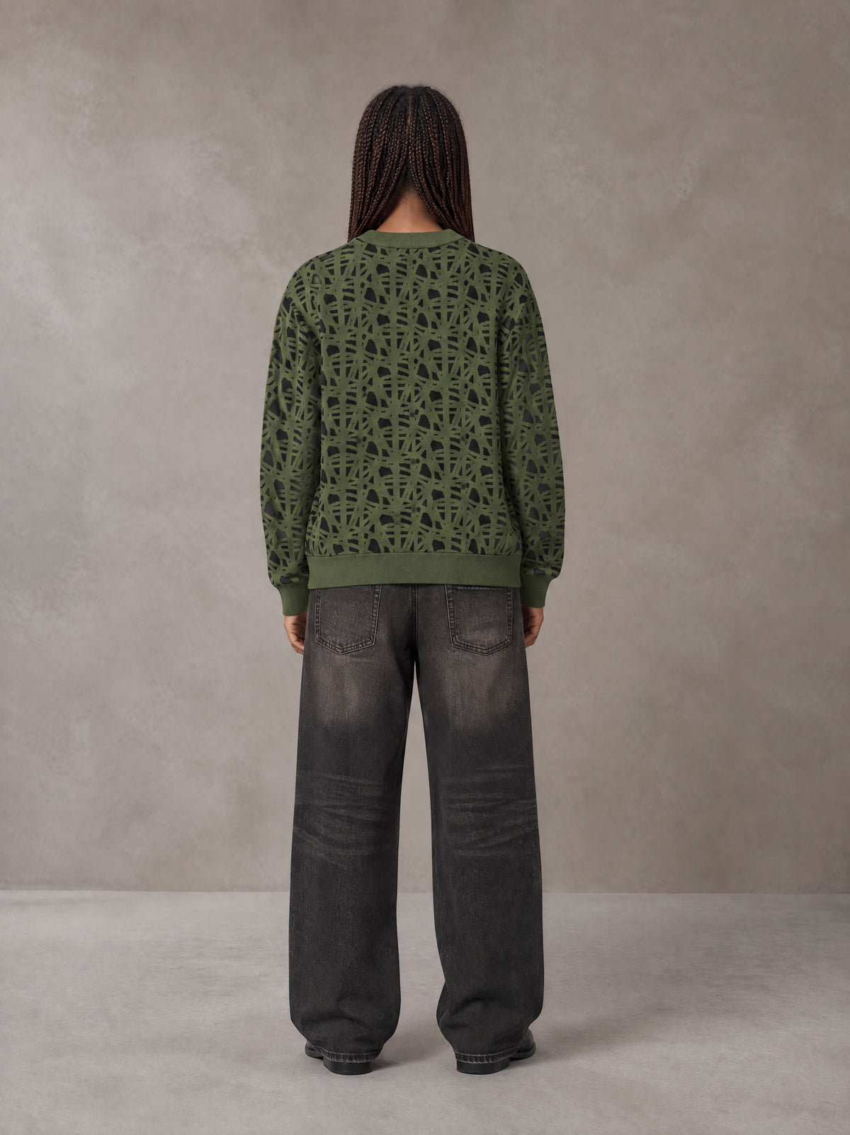 Model wearing the SM Abstract Jacquard Knitted Cardigan in Olive Shade, rear view.