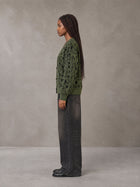 Model wearing the SM Abstract Jacquard Knitted Cardigan in Olive Shade, side profile.