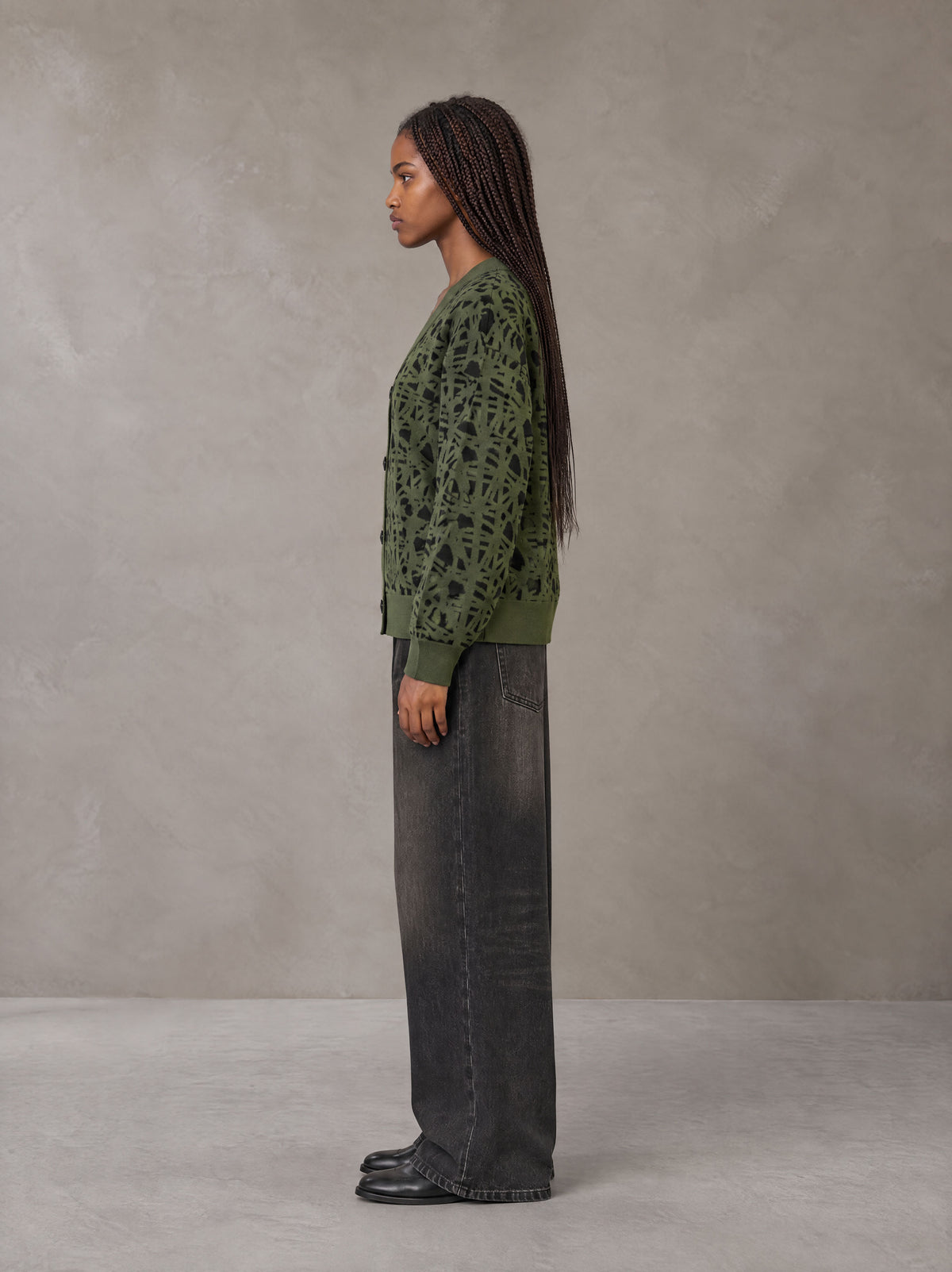 Model wearing the SM Abstract Jacquard Knitted Cardigan in Olive Shade, side profile.