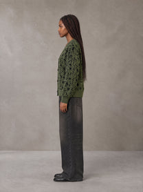 Model wearing the SM Abstract Jacquard Knitted Cardigan in Olive Shade, side profile.