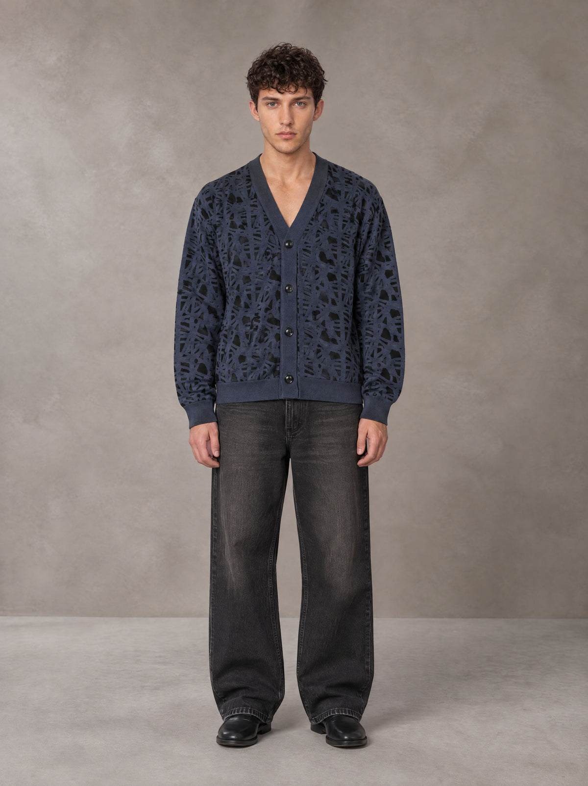 Model wearing the SM Abstract Jacquard Knitted Cardigan in Oxford Navy, front view.