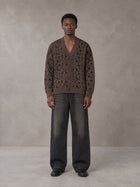 Model wearing the SM Abstract Jacquard Knitted Cardigan in Kabul Brown, front view.