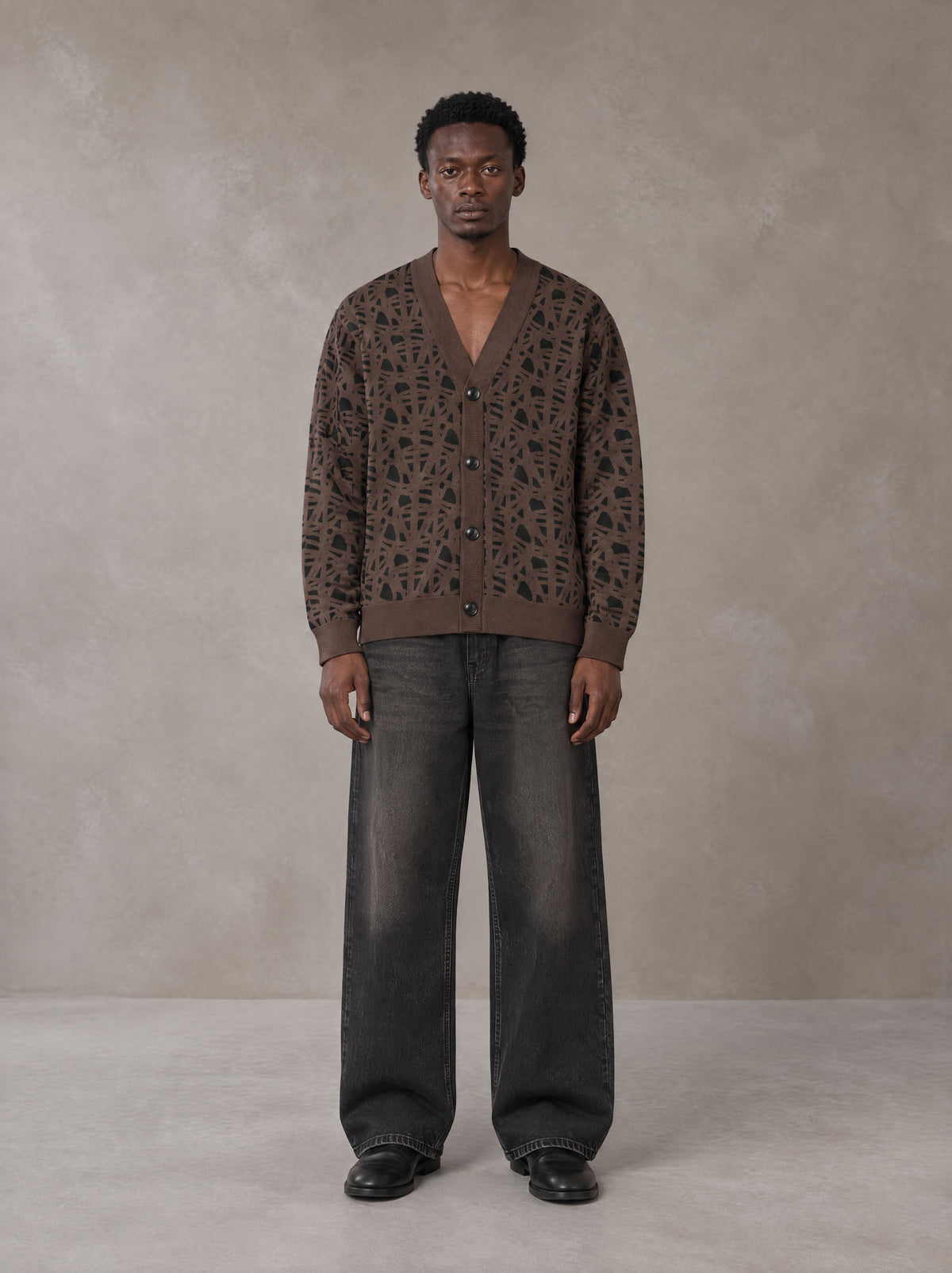 Model wearing the SM Abstract Jacquard Knitted Cardigan in Kabul Brown, front view.