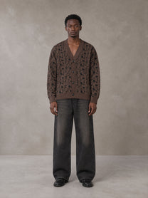 Model wearing the SM Abstract Jacquard Knitted Cardigan in Kabul Brown, front view.