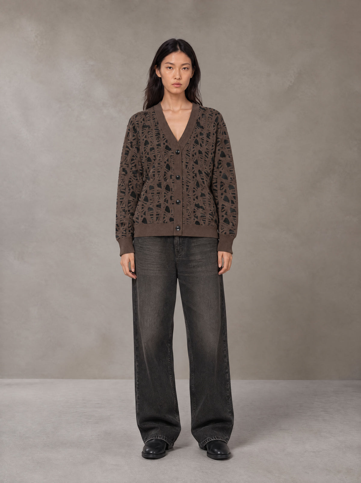 Model wearing the SM Abstract Jacquard Knitted Cardigan in Kabul Brown, front view.