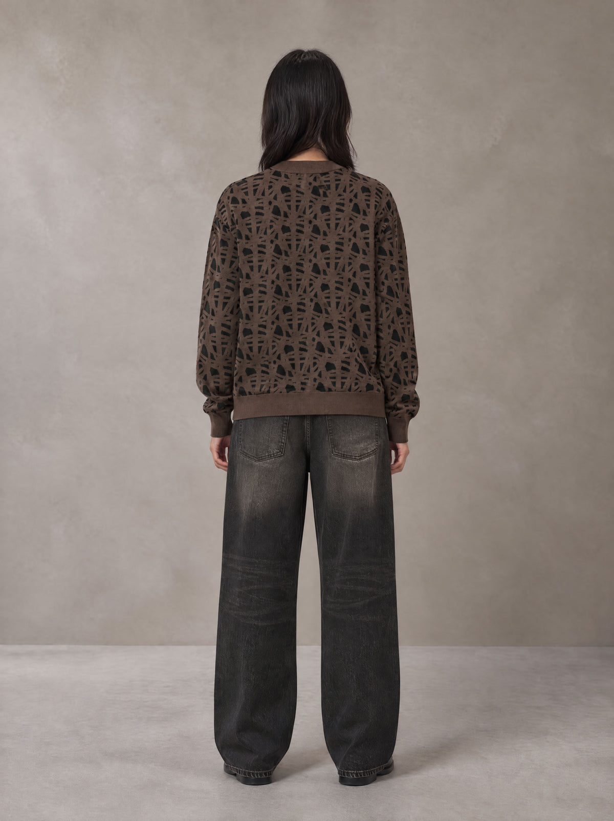 Model wearing the SM Abstract Jacquard Knitted Cardigan in Kabul Brown, rear view.