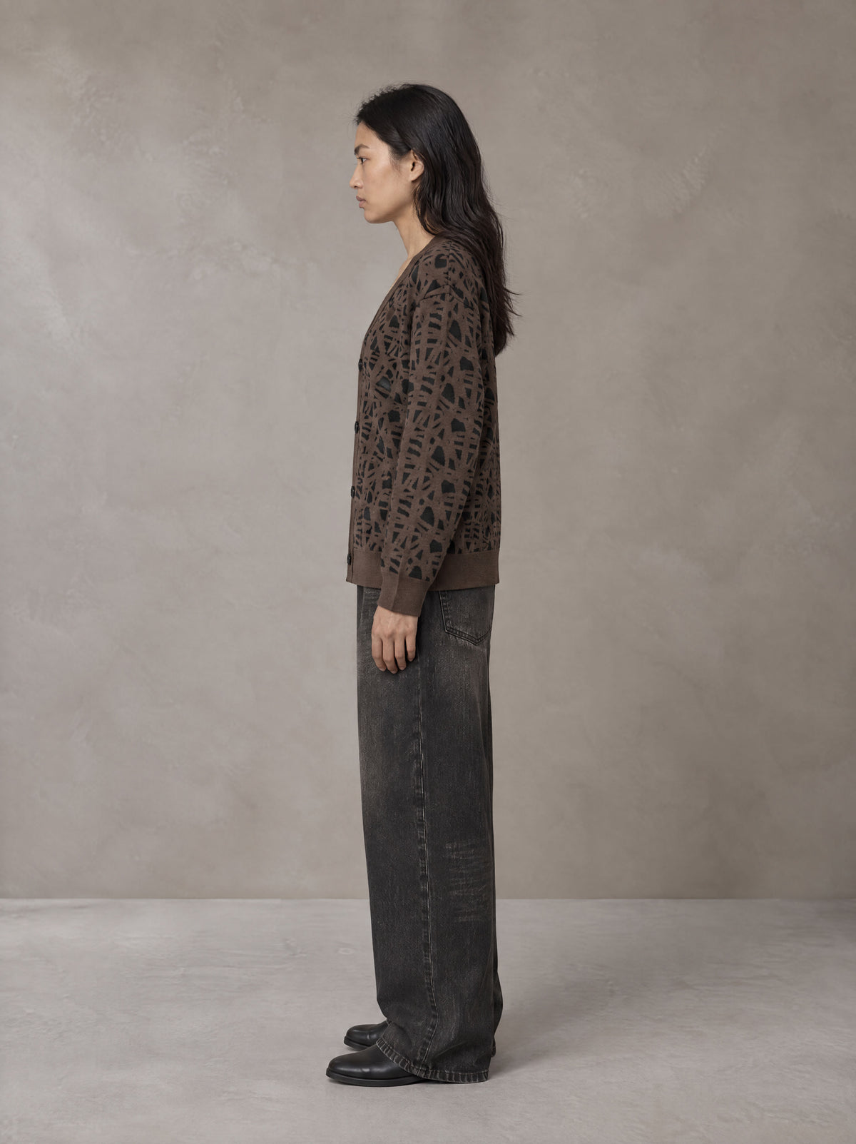 Model wearing the SM Abstract Jacquard Knitted Cardigan in Kabul Brown, side profile.