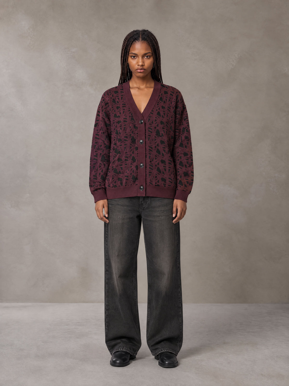 Model wearing the SM Abstract Jacquard Knitted Cardigan in Burgundy, front view.
