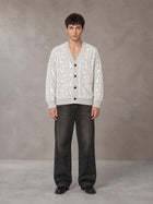 Model wearing the SM Abstract Jacquard Knitted Cardigan in Ivory White, front view.