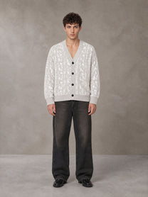 Model wearing the SM Abstract Jacquard Knitted Cardigan in Ivory White, front view.