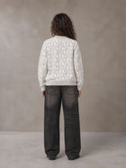 Model wearing the SM Abstract Jacquard Knitted Cardigan in Ivory White, rear view.
