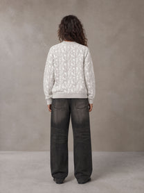 Model wearing the SM Abstract Jacquard Knitted Cardigan in Ivory White, rear view.